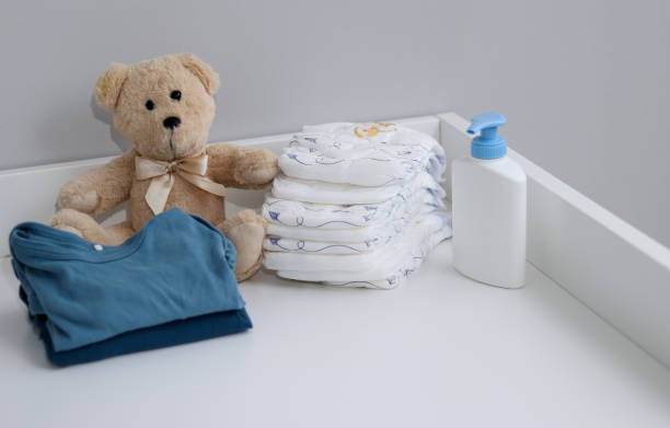 istock A stack of diapers, teddy bear and baby supplies on changing table 1995892277