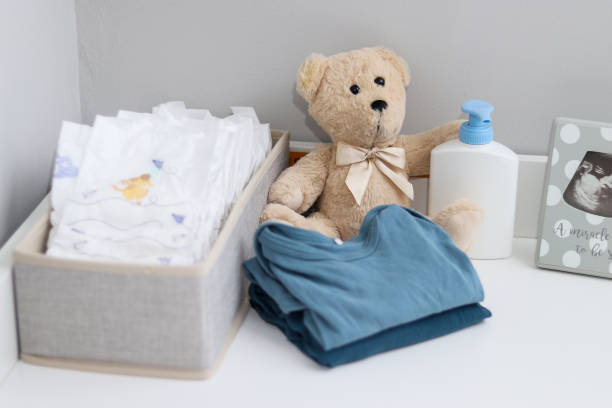 istock A stack of diapers, teddy bear and baby supplies on changing table 1995892278