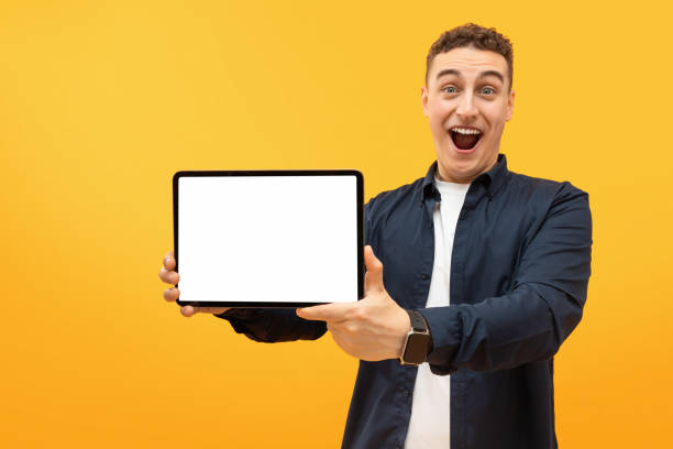 istock Excited young guy showing digital tablet with white screen 1995892279