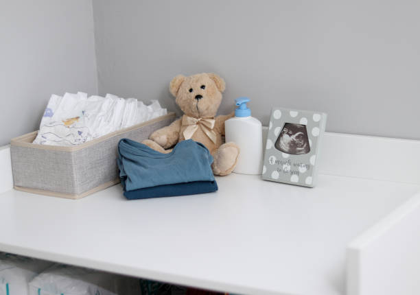 istock A stack of diapers, teddy bear and baby supplies on changing table 1995892281
