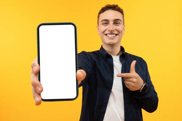 istock Portrait excited guy holding big smartphone with white blank screen 1995892294