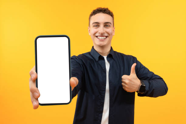 istock Handsome Excited Man Showing Smartphone With White Empty Screen 1995892299