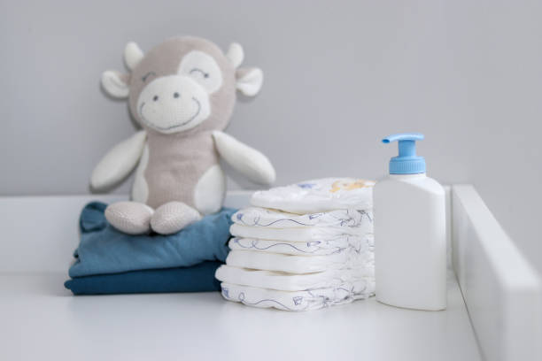 istock A stack of diapers, plush animal and baby supplies on changing table 1995892304