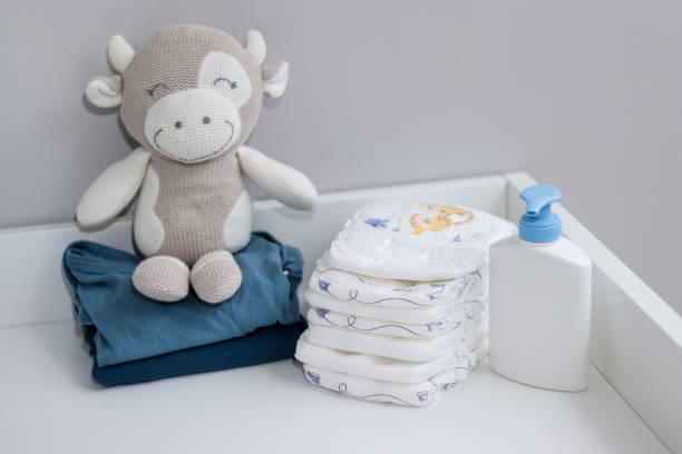 istock A stack of diapers, plush animal and baby supplies on changing table 1995892309