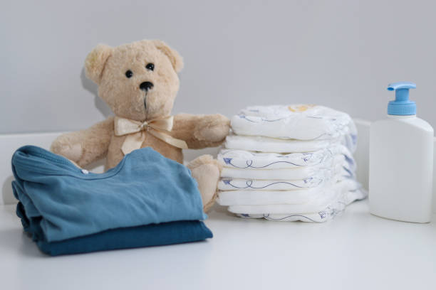 istock A stack of diapers, teddy bear and baby supplies on changing table 1995892311