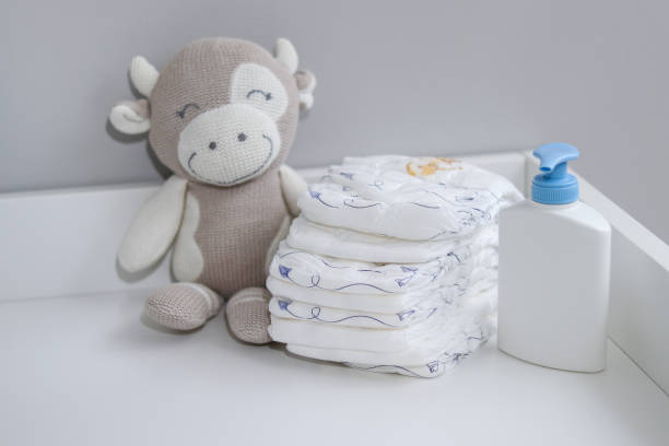 istock A stack of diapers, plush animal and baby supplies on changing table 1995893377