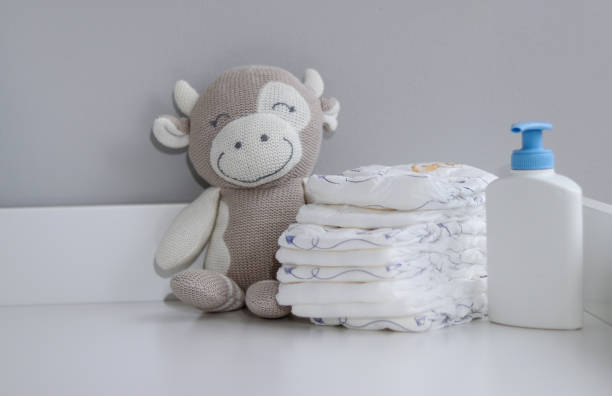 istock A stack of diapers, plush animal and baby supplies on changing table 1995893379