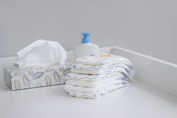 istock A stack A stack of diapers and baby supplies on white changing table 1995893391