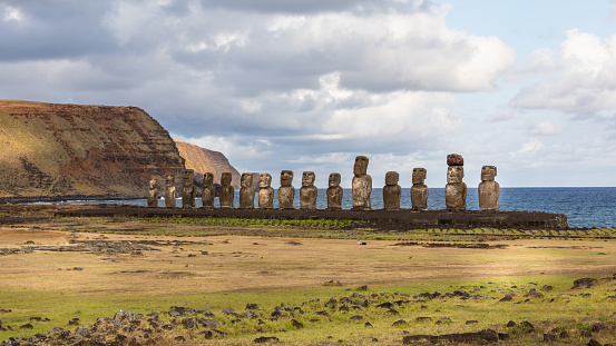 The 15 Moais, from Ahu Tongariki in the hilly landscape of Rapa Nui on the beautiful Pacific coast of Easter Island