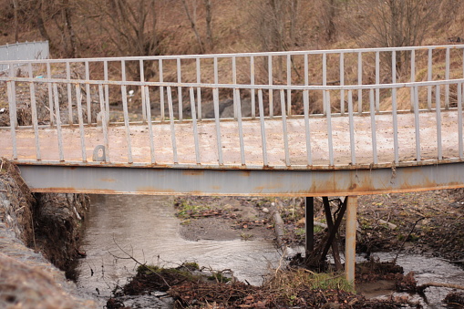 an old iron bridge over a mountain stream