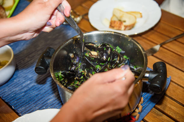 istock Preparing sea mussels for eat 1995922078