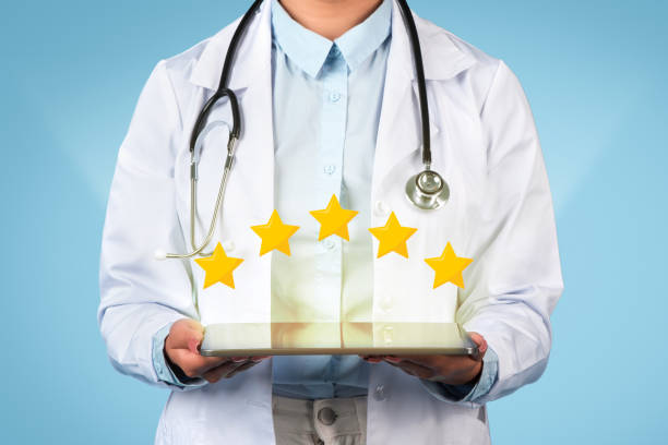 istock Doctor showing 5-star review on tablet 1995924258