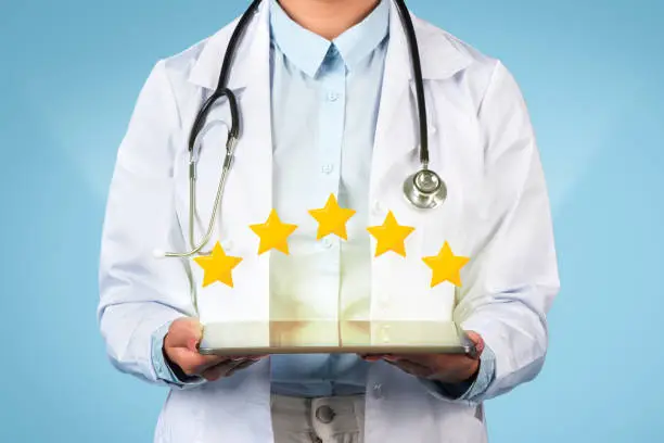 Photo of Doctor showing 5-star review on tablet