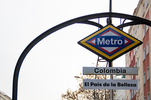 Metro station sign in Madrid, a station called Colombia that has been painted with its flag