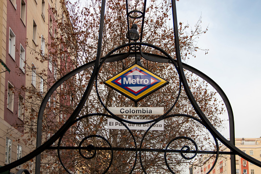 Metro station sign in Madrid, a station called Colombia that has been painted with its flag