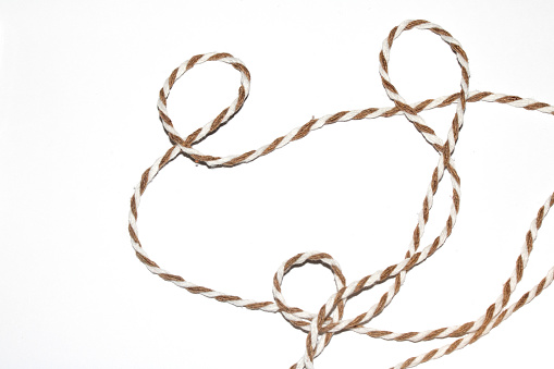 A Wrapping Paper Stripy String Rope Close Up on White Background
