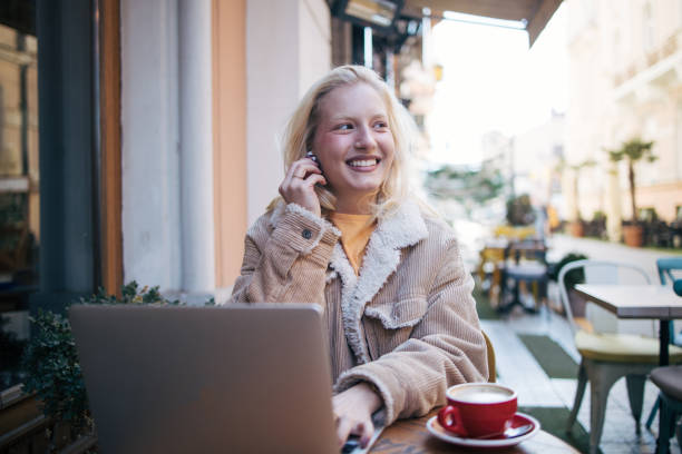 istock Young albino  woman using laptop in cafe 1995943109