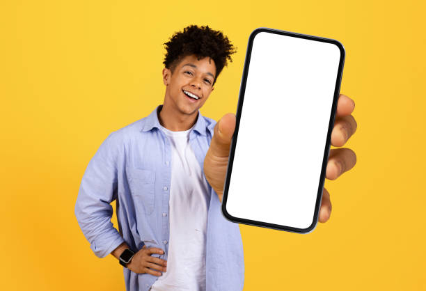 istock Black man with phone showing blank screen 1995948479