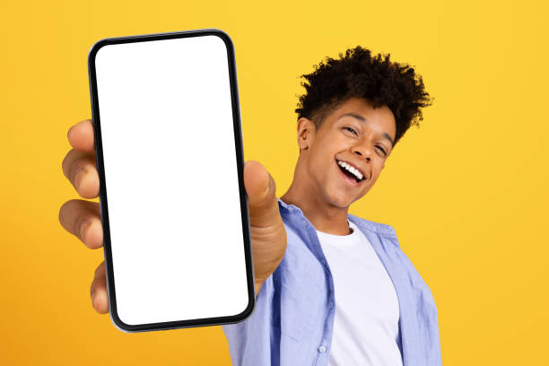 istock Happy black man showing phone screen 1995948491