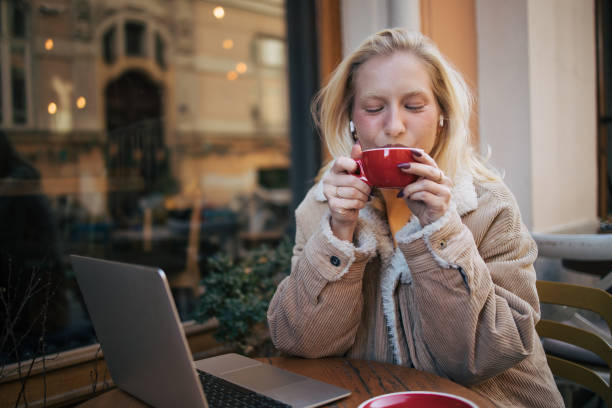 istock Young albino  woman using laptop in cafe 1995950353