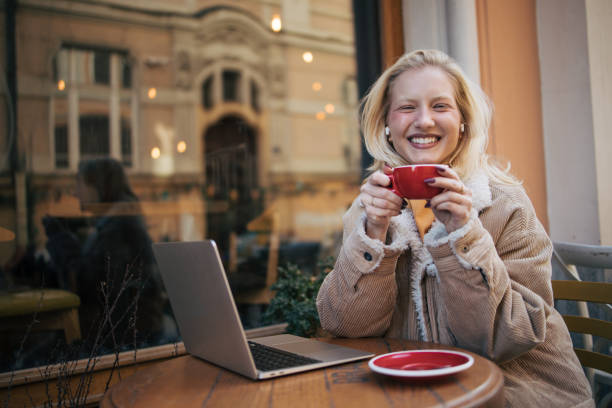 istock Young albino  woman using laptop in cafe 1995952137