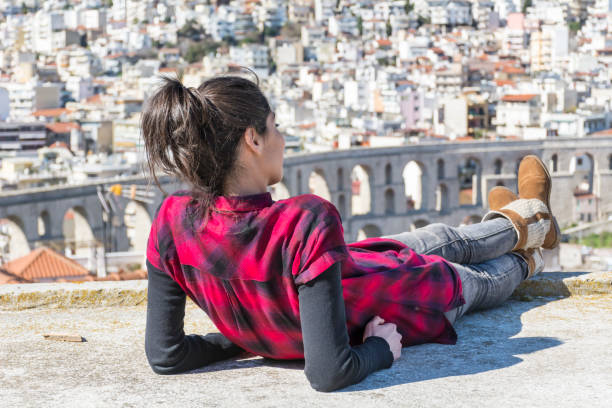 istock Sad Woman sitting alone on a rooftop 1995957400