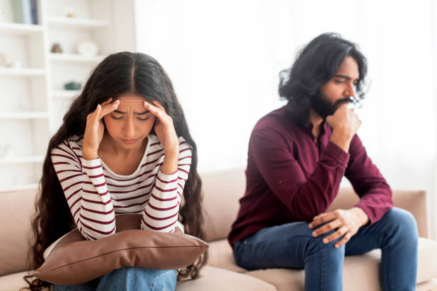 istock Upset young couple sitting on couch far from each other 1995963700