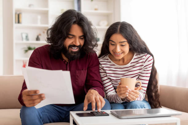 istock Indian Married Couple Planning Budget Together At Home 1995963721