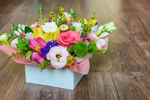 Flowers gift box on wooden background