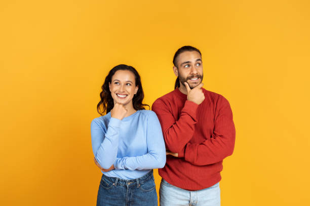 istock Excited millennial man and woman looking aside 1995979767