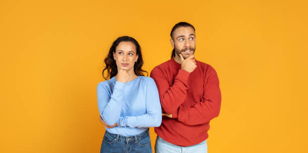 istock Pensive millennial man and woman looking aside 1995980303