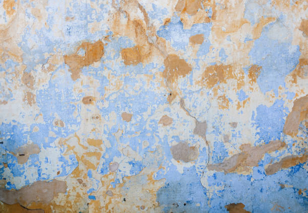 old wall with damaged plaster in pastel tones in Athens, Greece