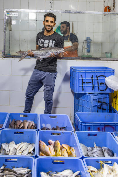 Middle East, Saudi Arabia, Madinah Province, Medina. November 20, 2023. Man at a fish market in Madinah.
