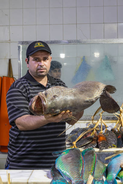 Middle East, Saudi Arabia, Madinah Province, Medina. November 20, 2023. Man at a fish market in Madinah.