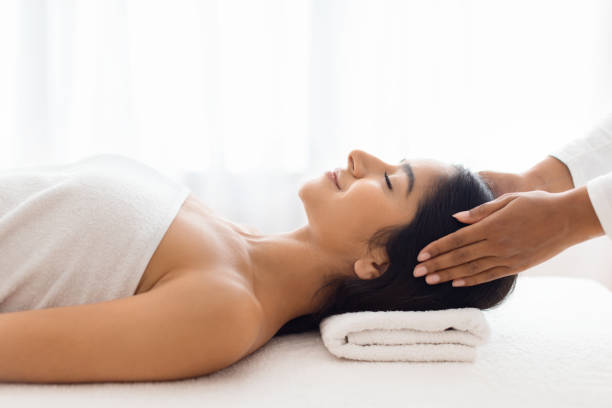 istock Calm woman indulging in a stress-relief head massage 1996004733