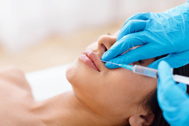 istock The doctor does injections to correct lip line 1996005838
