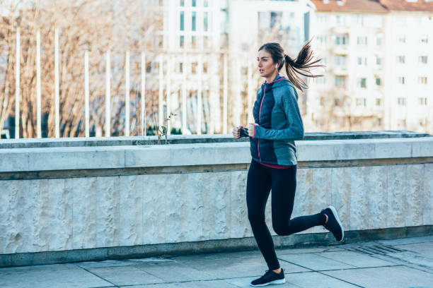 istock Woman jogging in the city 1996035996