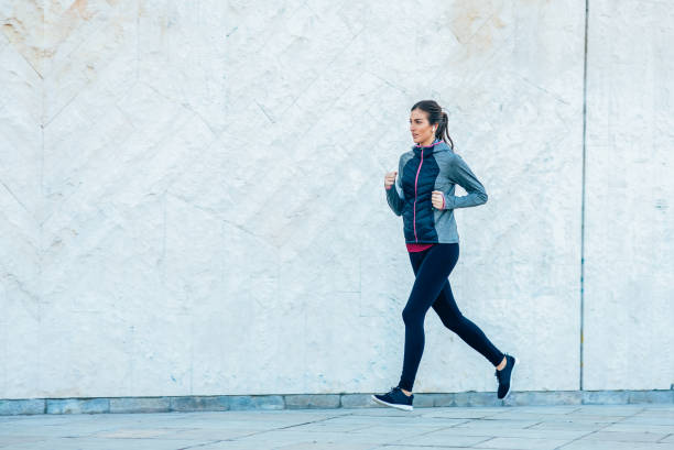 istock Woman jogging in the city 1996035997