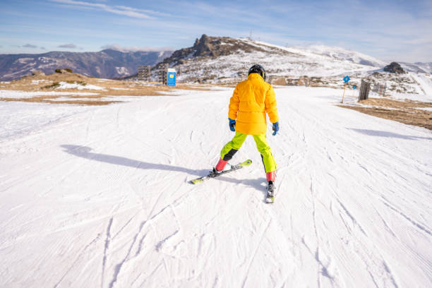 Group of friends skiing on winter holidays at the mountains having fun on the snow