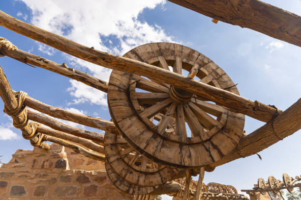 Middle East, Saudi Arabia, Tabuk Province, Tayma. Ancient wheels for hoisting water at a desert oasis.