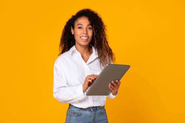 istock Cheerful African American lady engaging with digital tablet in studio 1996050515