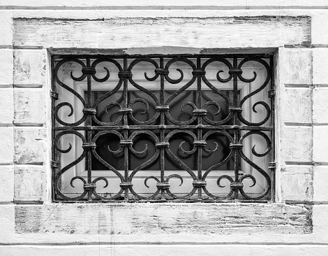 old window with ornamental grill