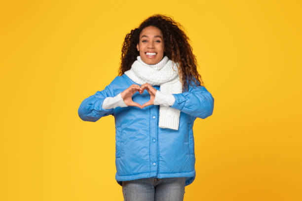 istock happy black lady makes heart gesture, joyful mood 1996066684