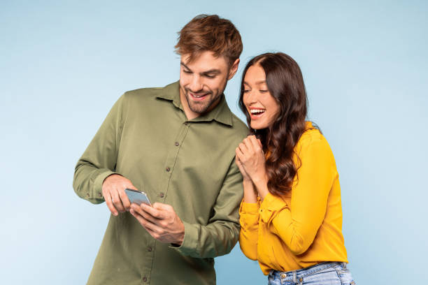 istock Happy couple sharing content on a phone, enjoying a moment together 1996095098