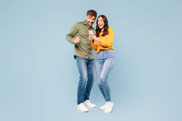 istock Happy couple viewing smartphone together, joyful interaction 1996095145