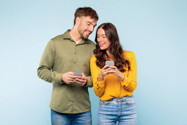 istock Smiling couple sharing moment over smartphones, casually connected 1996095166