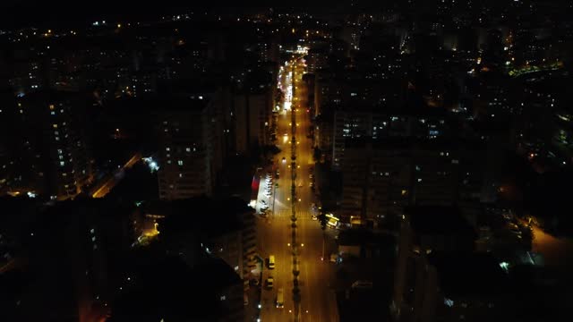 Night city, darkness contrasts with vibrant lights in Mersin, night city, darkness unveils urban beauty, night city, darkness pierced by glowing streets