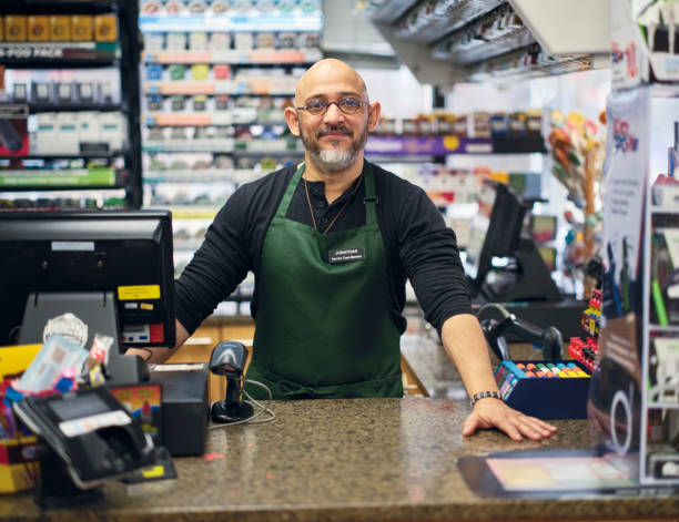 istock Small Business Owner at Work in His Small Convenience Store 1996144232