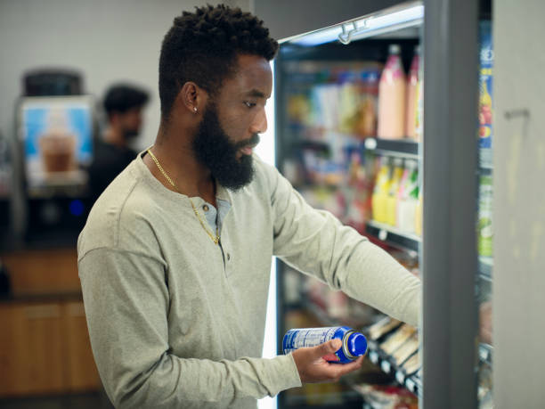 istock Young Man Buying Drinks in a Convenience Store 1996149405