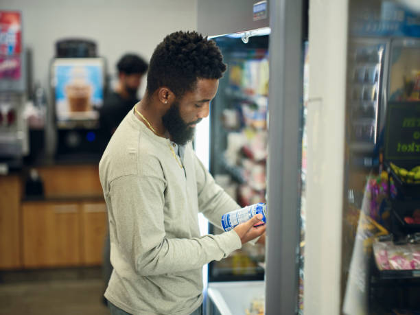 istock Young Man Buying Drinks in a Convenience Store 1996149921